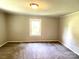 Spacious bedroom with neutral carpeting and a window at 503 Broad St, Kings Mountain, NC 28086