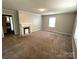 Living room with neutral carpeting and a fireplace at 503 Broad St, Kings Mountain, NC 28086