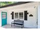 Quaint front porch with teal door and black bench at 1378 8Th Nw St, Hickory, NC 28601