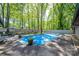 Relaxing pool area with ample seating and a tranquil wooded backdrop at 315 Camelot Dr, Salisbury, NC 28144