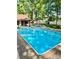 Inviting in-ground pool with surrounding patio and lush landscaping at 315 Camelot Dr, Salisbury, NC 28144