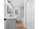 Modern bathroom with white cabinets, marbled shower, and wood-look floors at 3503 Linwood Rd, Gastonia, NC 28052