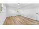 This bedroom is bright and airy with light colored walls and wood-look floors at 3503 Linwood Rd, Gastonia, NC 28052