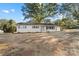 Charming white home featuring a covered porch and a light blue front door at 3503 Linwood Rd, Gastonia, NC 28052