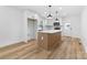 Modern kitchen with a center island, white cabinets, pendant lights, and updated appliances at 3503 Linwood Rd, Gastonia, NC 28052