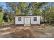 Exterior view of a storage shed with white siding, a brown roof, and double doors at 3503 Linwood Rd, Gastonia, NC 28052