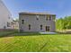 Spacious backyard featuring a well-maintained lawn, patio area, and the rear of the home at 48 Sherwood Nw Ct # Sw48, Concord, NC 28027