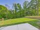 Expansive backyard with lush green lawn and mature trees, perfect for outdoor activities and relaxation at 48 Sherwood Nw Ct # Sw48, Concord, NC 28027