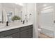 Modern bathroom featuring dual sinks, gray cabinets, a large mirror, and a shower-tub combo at 48 Sherwood Nw Ct # Sw48, Concord, NC 28027