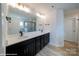 Modern bathroom with double vanity, black fixtures, and glass enclosed shower in the background at 48 Sherwood Nw Ct # Sw48, Concord, NC 28027