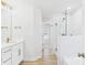A bright bathroom is shown, featuring white cabinets, countertops, and a glass-enclosed shower with gold fixtures at 48 Sherwood Nw Ct # Sw48, Concord, NC 28027