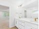 This well-lit bathroom features dual sinks with gold fixtures, a large mirror, and a shower with glass enclosure at 48 Sherwood Nw Ct # Sw48, Concord, NC 28027