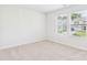 Bright bedroom featuring two windows offering plenty of natural light and a view of the neighborhood at 48 Sherwood Nw Ct # Sw48, Concord, NC 28027