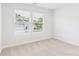 Bright bedroom featuring two windows offering plenty of natural light and a view of the neighborhood at 48 Sherwood Nw Ct # Sw48, Concord, NC 28027