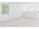 Bonus room with neutral carpet, chandelier, and large window providing great light at 48 Sherwood Nw Ct # Sw48, Concord, NC 28027