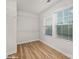 A bright walk-in closet with laminated floors is equipped with wire shelving, complemented by two windows for natural light at 48 Sherwood Nw Ct # Sw48, Concord, NC 28027