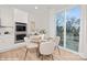 Dining area with a glass table, seating for four, and a sliding glass door to a deck at 48 Sherwood Nw Ct # Sw48, Concord, NC 28027