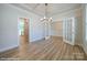 Dining room with decorative lighting, wood floors, and entryways with wainscotting details at 48 Sherwood Nw Ct # Sw48, Concord, NC 28027