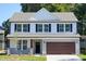 Charming two-story home featuring a gray roof, black shutters, and a two-car garage with stone accents at 48 Sherwood Nw Ct # Sw48, Concord, NC 28027