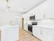 Modern kitchen featuring white cabinets, stainless steel appliances, and a large center island at 48 Sherwood Nw Ct # Sw48, Concord, NC 28027
