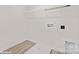 A minimalist laundry area includes laminate flooring, essential hookups, and wire shelving, creating a practical and functional space at 48 Sherwood Nw Ct # Sw48, Concord, NC 28027