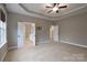 Bedroom featuring tray ceilings, neutral carpet, and open doorway to the bathroom at 507 Quicksilver Trl, Fort Mill, SC 29708