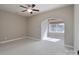 Bedroom featuring neutral carpet, tray ceiling, and an arched entryway at 507 Quicksilver Trl, Fort Mill, SC 29708