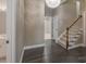 Foyer area featuring hardwood flooring, stairs with wood banister, and a modern light fixture at 507 Quicksilver Trl, Fort Mill, SC 29708