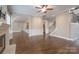 Open living area featuring a stone fireplace, hardwood floors, and an arched entrance at 507 Quicksilver Trl, Fort Mill, SC 29708