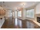 Bright living room featuring hardwood floors, neutral walls, and a fireplace, creating an inviting and elegant space at 507 Quicksilver Trl, Fort Mill, SC 29708