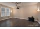 A large room with black hardwood flooring, a projector and a ceiling fan at 507 Quicksilver Trl, Fort Mill, SC 29708