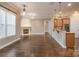 Open floor plan connecting the living room with a fireplace to a cozy breakfast bar and kitchen at 507 Quicksilver Trl, Fort Mill, SC 29708