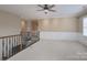 Upstairs loft space with neutral carpet, paint, and a ceiling fan at 507 Quicksilver Trl, Fort Mill, SC 29708