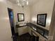 Bathroom with vanity, black countertop and mirrors at 2022 Friendship Church Rd, Taylorsville, NC 28681