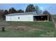 Metal building with double garage doors and covered workspace at 2022 Friendship Church Rd, Taylorsville, NC 28681