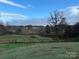 Farmland with distant view of buildings and pond at 2022 Friendship Church Rd, Taylorsville, NC 28681