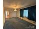 Spacious living room with blue carpet and chandelier at 2022 Friendship Church Rd, Taylorsville, NC 28681