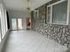 Sunroom with tile floors and stone wall at 2022 Friendship Church Rd, Taylorsville, NC 28681