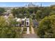 Aerial view of a modern home with a skyline backdrop surrounded by lush green trees at 217 Keswick Ave, Charlotte, NC 28206