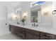 Spacious bathroom with double vanity, white countertops, dark wood cabinets, and modern fixtures at 217 Keswick Ave, Charlotte, NC 28206