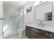 Bathroom featuring tiled shower with glass door, modern vanity, and a sleek design at 217 Keswick Ave, Charlotte, NC 28206