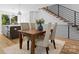 Dining area with a wood table, seating for four, an area rug and view into the kitchen at 217 Keswick Ave, Charlotte, NC 28206