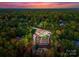 Breathtaking aerial view of estate nestled amidst lush greenery with expansive backyard and putting green at 2723 Providence Pine Ln, Charlotte, NC 28270