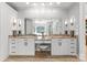 Bright bathroom featuring double vanity with granite countertops, white cabinetry, and large mirrors at 2723 Providence Pine Ln, Charlotte, NC 28270