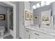 Bathroom featuring a marble vanity, white cabinetry, and a glass-enclosed shower/bath combination at 2723 Providence Pine Ln, Charlotte, NC 28270