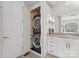 Bathroom featuring stacked washer/dryer hidden in a cabinet, granite countertop and tiled floor at 2723 Providence Pine Ln, Charlotte, NC 28270