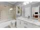 Bathroom features a marble vanity, white cabinets, glass shower, and a sun-filled window at 2723 Providence Pine Ln, Charlotte, NC 28270