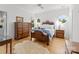 Well-lit bedroom with hardwood floors, classic furniture, and neutral colors creating a calming atmosphere at 2723 Providence Pine Ln, Charlotte, NC 28270