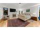 Spacious main bedroom featuring a fireplace, sitting area, hardwood floors, and a large bed at 2723 Providence Pine Ln, Charlotte, NC 28270