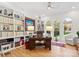 Inviting home office featuring a built-in bookcase, a classic desk, and three large windows at 2723 Providence Pine Ln, Charlotte, NC 28270